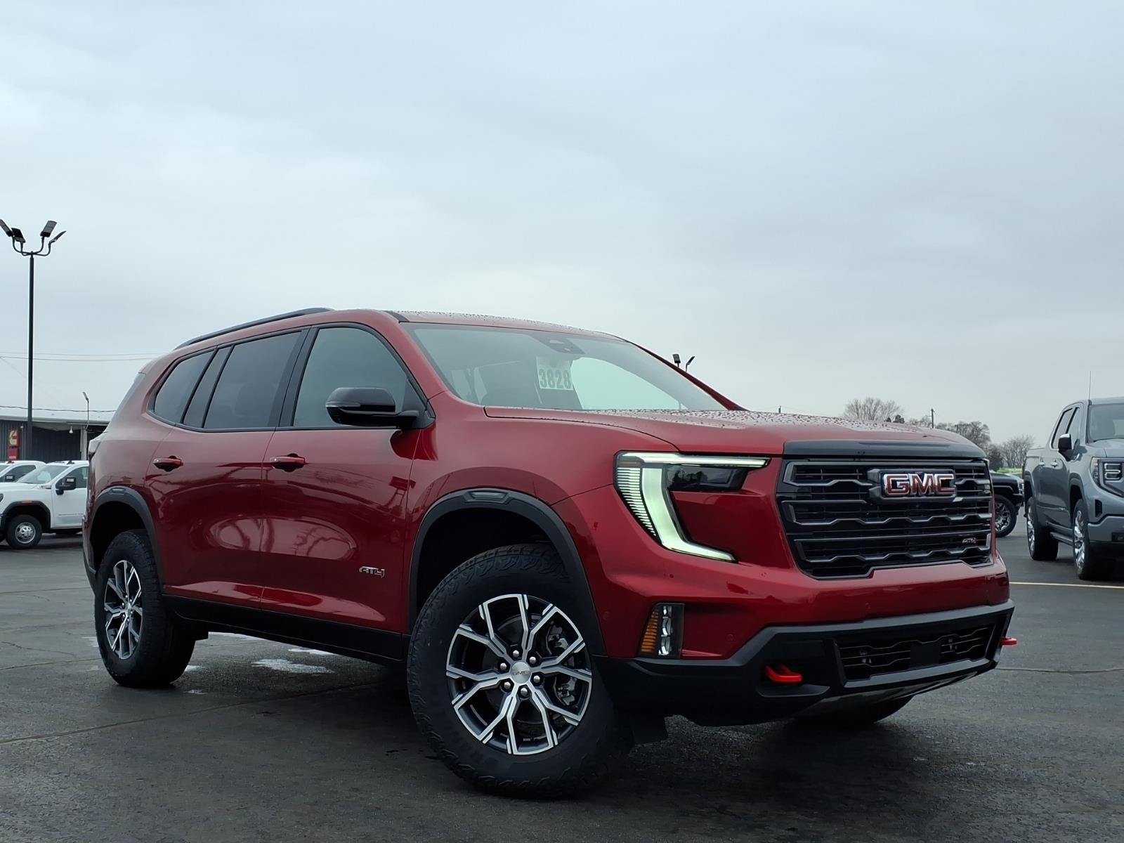 2026 GMC Acadia AT4 in Volcanic Red Tintcoat — front three-quarter view