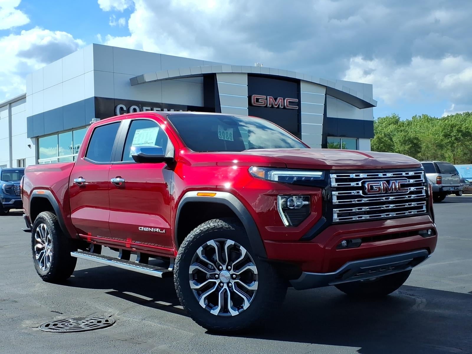 2026 GMC Canyon Denali in Volcanic Red Tintcoat — front three-quarter view